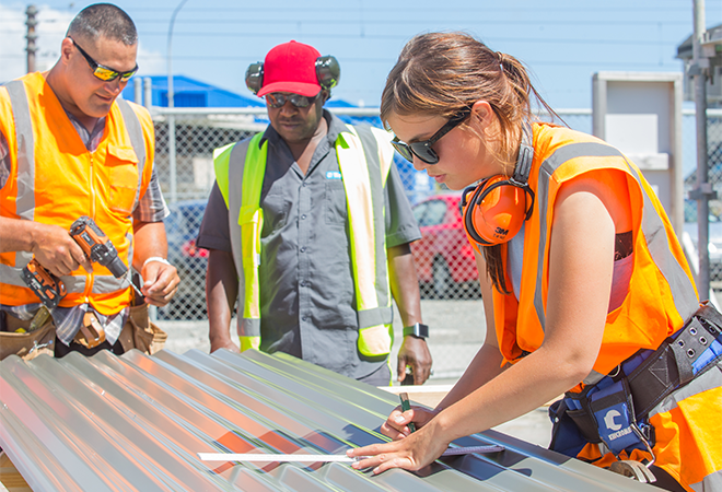 An apprentice is being observed in the construction industry.